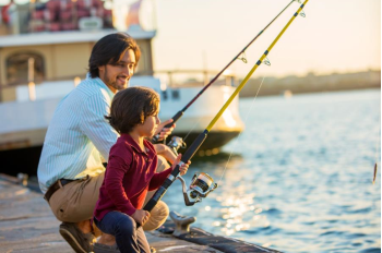 man and son fishing on dock